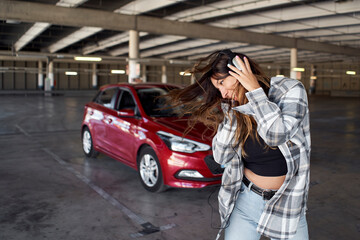 Fototapeta na wymiar Young woman dancing in a parking lot.