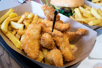 Delicious and unhealthy fast food - golden chicken nuggets with french fries