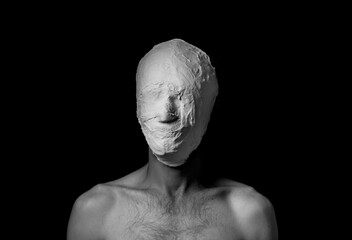 black and white photo of a man in a plaster mask