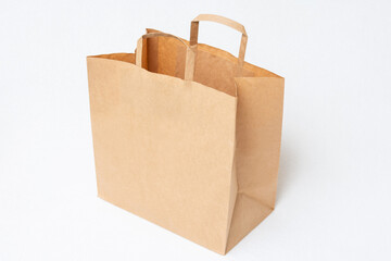 Brown craft bag, white background, side view, copy space
