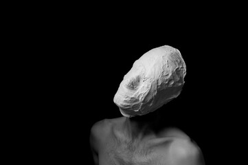 black and white photo of a man in a plaster mask