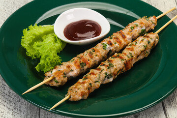 Minced pork skewer kebab with sauce