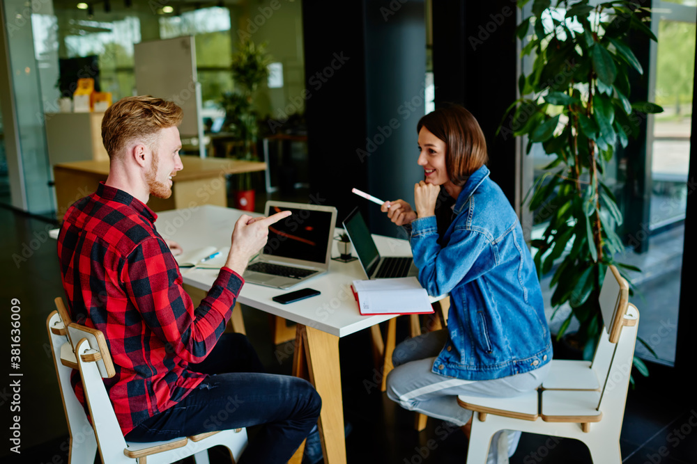 Poster side view of caucasian male and female students enjoying collaborative meeting for discussing projec