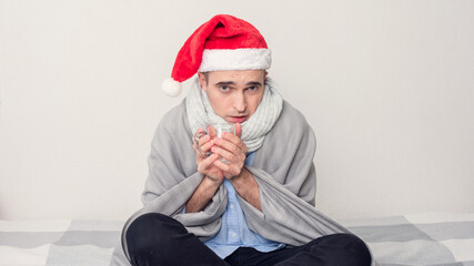 Unhappy Santa with a Cup of water, a man sitting at home on self-isolation, portrait, white...