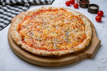 Pizza Quattro formaggi on white concrete table