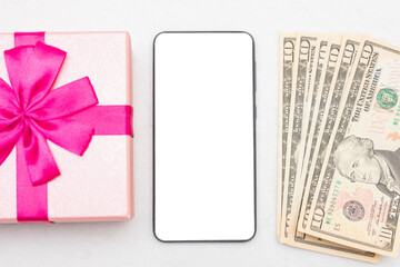 USA dollars, pink gift and phone, white background, closeup, copy space, top view