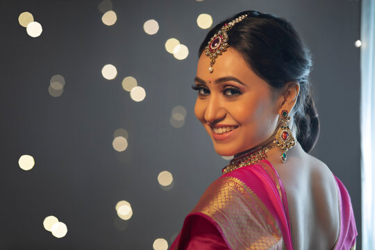 Woman in saree smiling confidently	