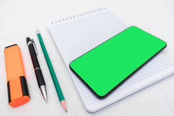 Office supplies and smartphone, close-up, top view, copy space
