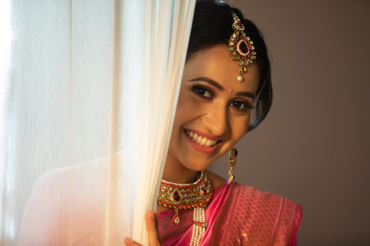 Beautiful bride smiling from the curtain	