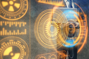 Technology theme hologram with man working on computer on background. High tech concept. Multi exposure.