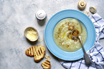 Cauliflower soup with mushrooms and cheese. Top view with copy space.