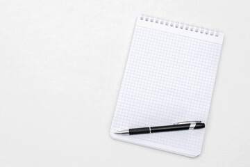 Spiral white notepad and ballpoint pen, top view, white background, copy space