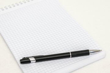 White notepad and black pen, top view, copy space