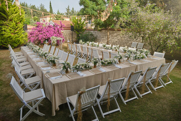 Dining table decoration. Dining table decoration in the garden. Invitation dinner, wedding dinner, engagement dinner