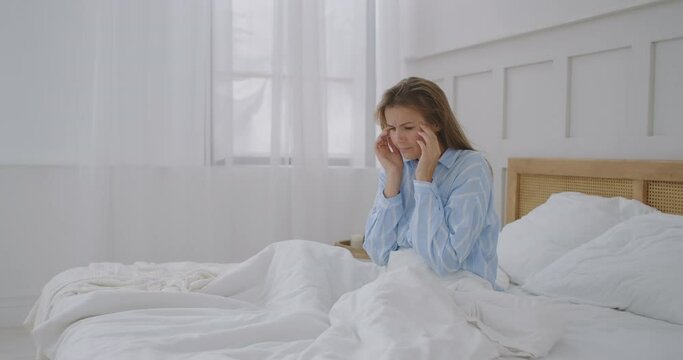 Woman holding head. Woman having head pain at home. Woman having headache. My head feels like it is going to explode