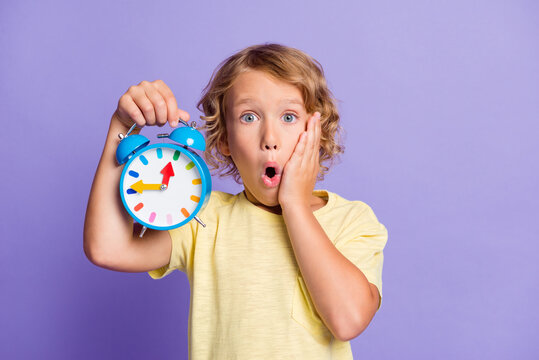 Photo of frustrated kid feel worried show clock missed late time concept isolated over purple color background