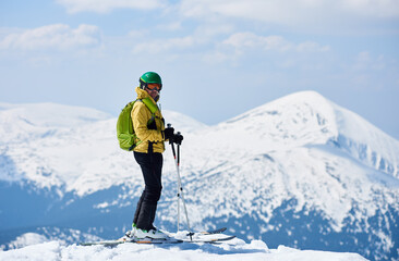 Fototapeta na wymiar Sporty man enjoying skiing day and spectacularly view mountain landscape under blue sky Snow and winter activities, skitouring in mountains.