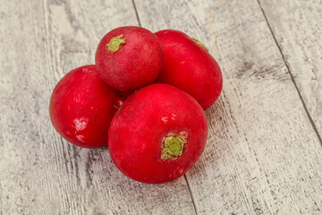 Ripe fresh radish heap over wooden