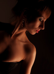 Lingerie model woman over dark background