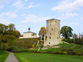 Fototapeta na wymiar View of the medieval old stone Rattling tower in the Pskov city, Russia in the bright autumn day