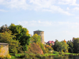 Fototapeta na wymiar View of the medieval old stone Rattling tower in the Pskov city, Russia in the bright autumn day