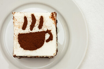 Chocolate cake, drawing in the form of a Cup of coffee, top view, copy space