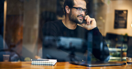 Content ethnic man talking on smartphone