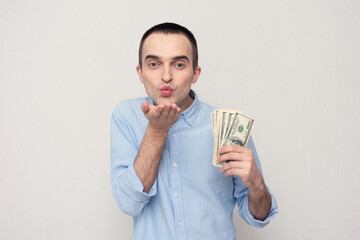 In love man with the cash dollars blows air kiss, white background, copy space
