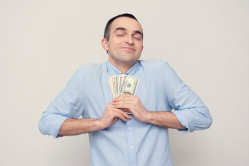Very happy guy with first salary, white background, copy space