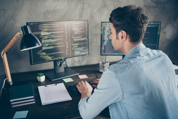 Rear back behind view portrait of his he nice attractive focused geek guy typing css analyzing...