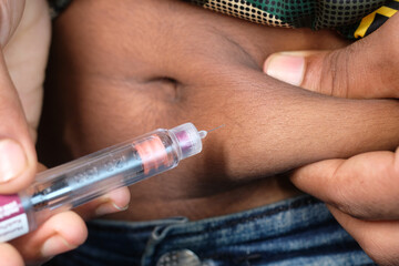 close up of young man hand using Insulin pen