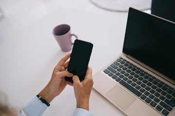 Anonymous woman messaging on smartphone