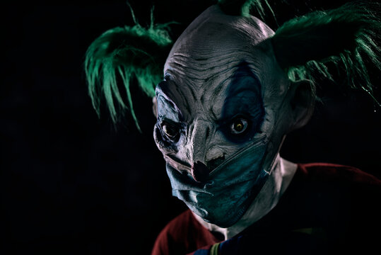 disturbing evil clown wearing a face mask