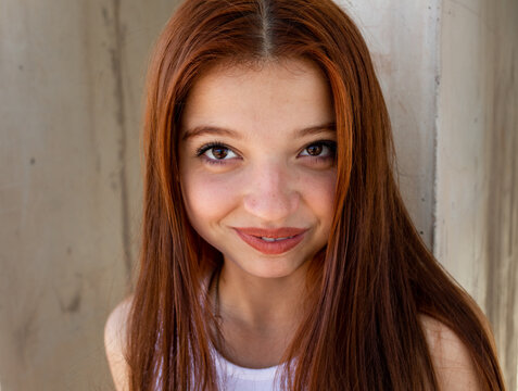 Beautiful redhead girl seeing camera and smiling