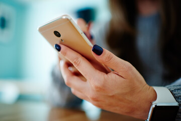 Woman messaging on modern smartphone