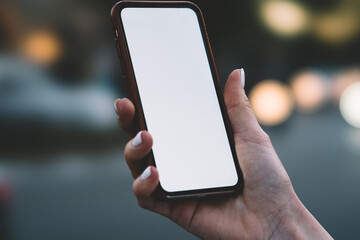 Hand of unrecognizable woman taking smartphone