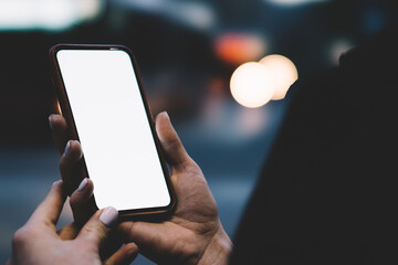 Anonymous woman using smartphone in city