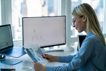 Fototapeta na wymiar Positive female manager analyzing data in office