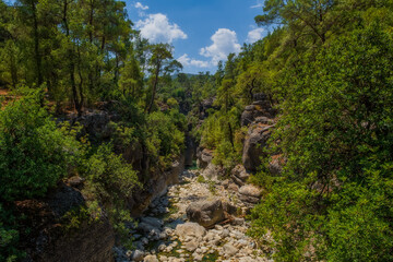 Fototapeta na wymiar Creek eroded rocks. Flowing stream between rocks. Antalya Koprulu Canyon. Turkey, august 2020