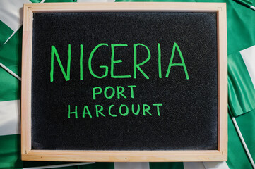 Happy independence day of Nigeria, Port Harcourt. Text on board with nigerian flags.