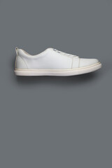 White casual shoes on gray background