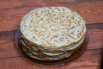 Zucchini pancakes on a wooden table.