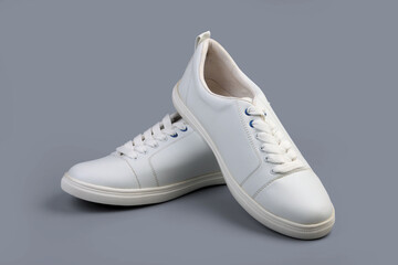 White casual shoes on gray background