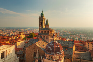 Fototapeta na wymiar Bergamo city - Scenic sunse view of the Old city and Basilica of Santa Maria Maggiore and Cappella Colleoni in Citta Alta, Italy 