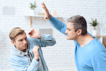 Father scares a worried teenager raising his hand.