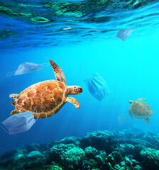 Garbag surgical face mask floating in the ocean dangerous to sea turtle or wildlife in the sea world Manipulation in the ocean pollution during Covid-19 pandemic