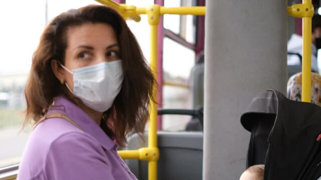 A mother with her child rides on public transport wearing protective masks during the second wave of the covid-19 coronavirus.
