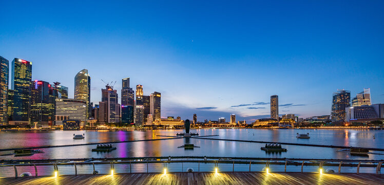 Wide panorama image of Singapore skyscrapers at magic hour before COVID-19 pandemic.