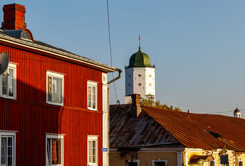 Vyborg street in autumn. Old historic houses, Vyborg Castle and St. Olav Tower, the Clock Tower.
