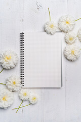 Notebooks and flowers-The book and white flowers on the white wooden table